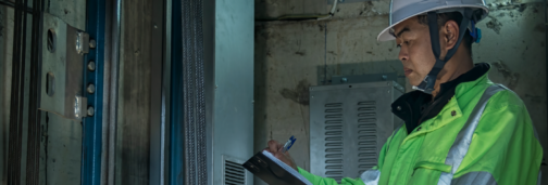 Maintenance man in elevator shaft